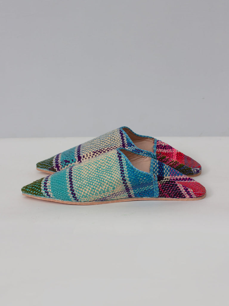 Side view of limited edition Moroccan Boujad Pointed Babouche Slippers with a stripe pattern in blue green and fuchsia pink tones. 