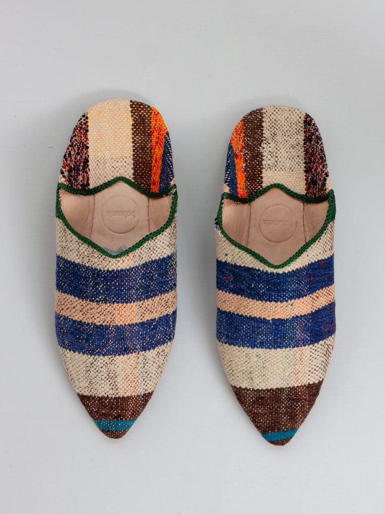 Moroccan pointed babouche slippers made from leather and vintage boujad fabric in natural, brown and blue stripes.