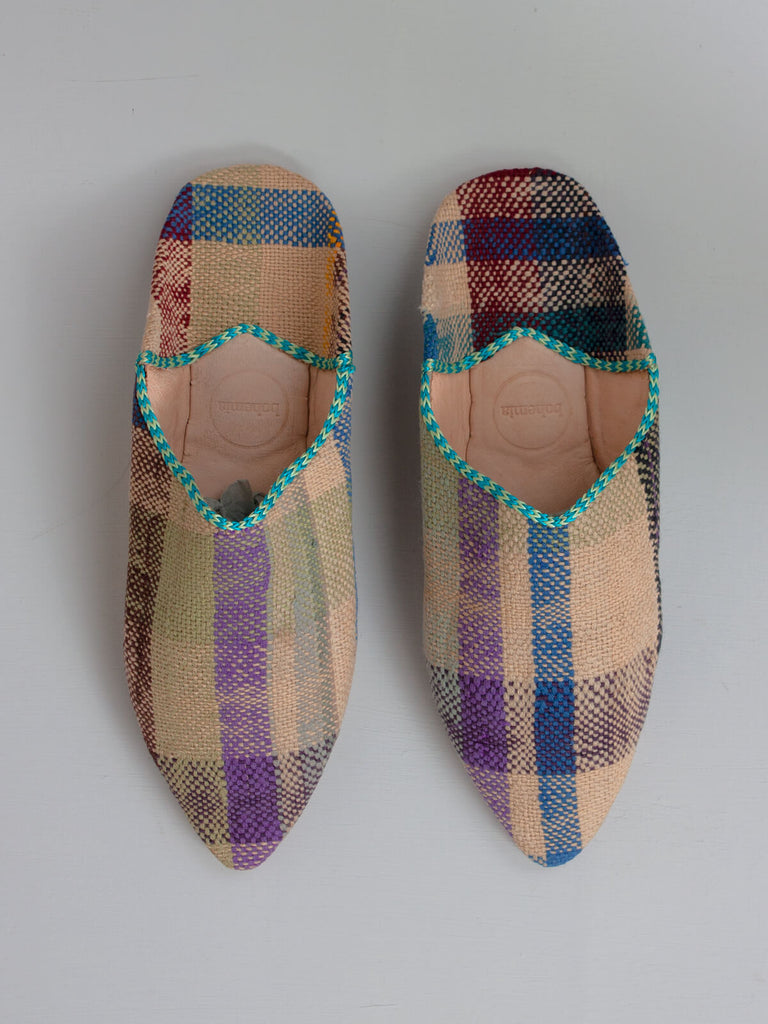 A pair of limited edition textile and leather Moroccan boujad pointed babouche slippers with a natural check pattern. 