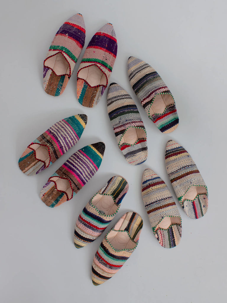 Three pairs of limited edition Moroccan boujad fabric and leather pointed babouche slippers with unique pastel stripe patterns. 