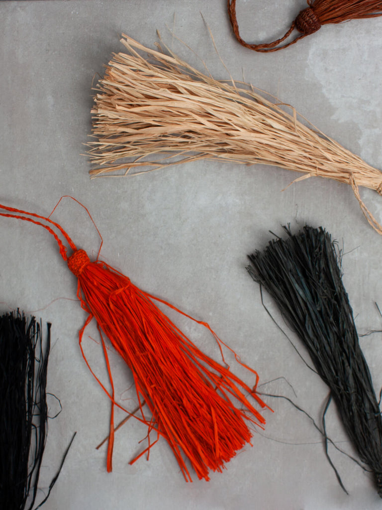 Red, grey, natural and black raffia tassels from above
