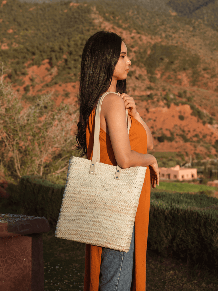 Asilah Shopper Basket by Bohemia Design worn by a woman overlooking Moroccan mountains