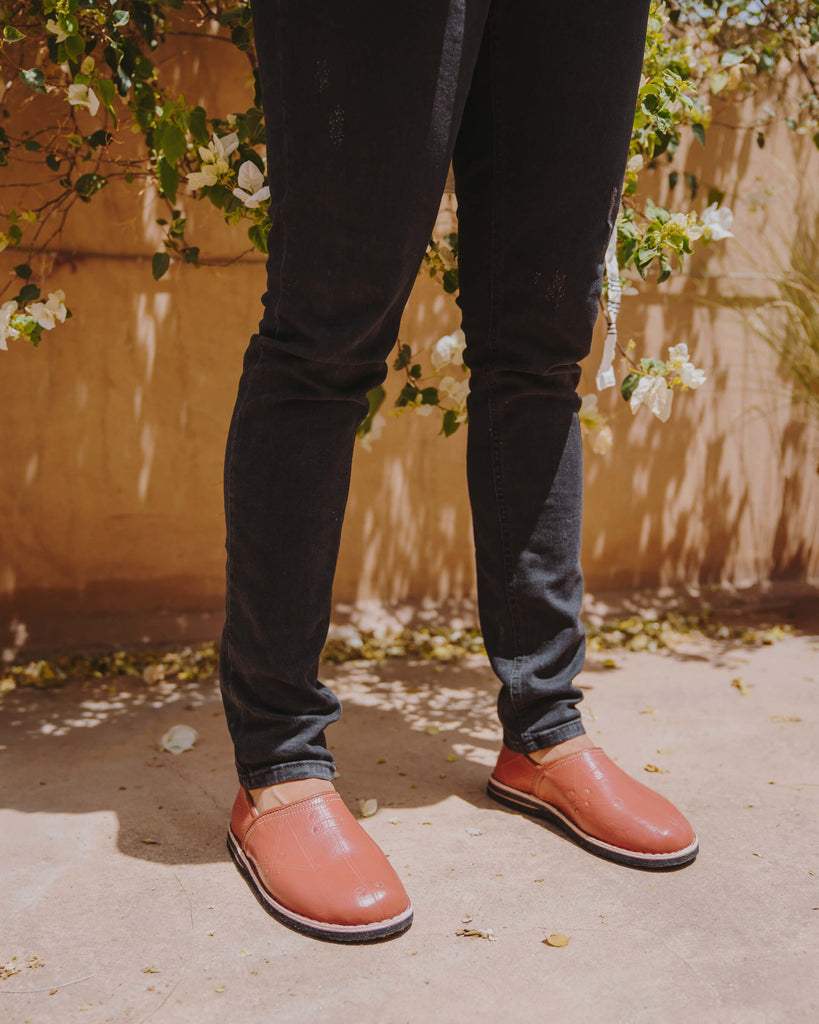 Berber babouche slippers in terracotta leather worn by model in dark skinny jeans