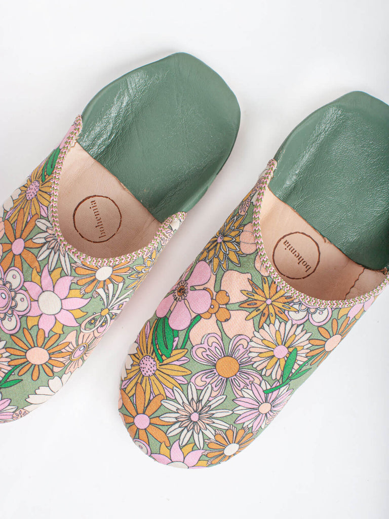 A pair of Moroccan babouche slippers in an olive and pink floral pattern by Bohemia Design