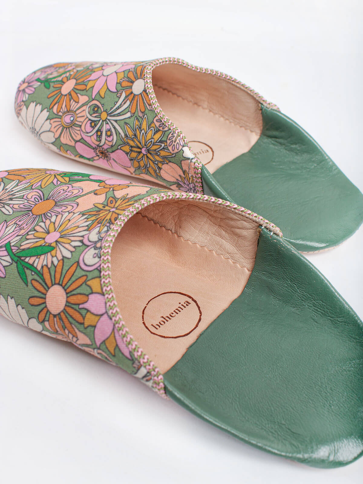 A pair of Moroccan babouche slippers in an olive and pink floral pattern by Bohemia Design