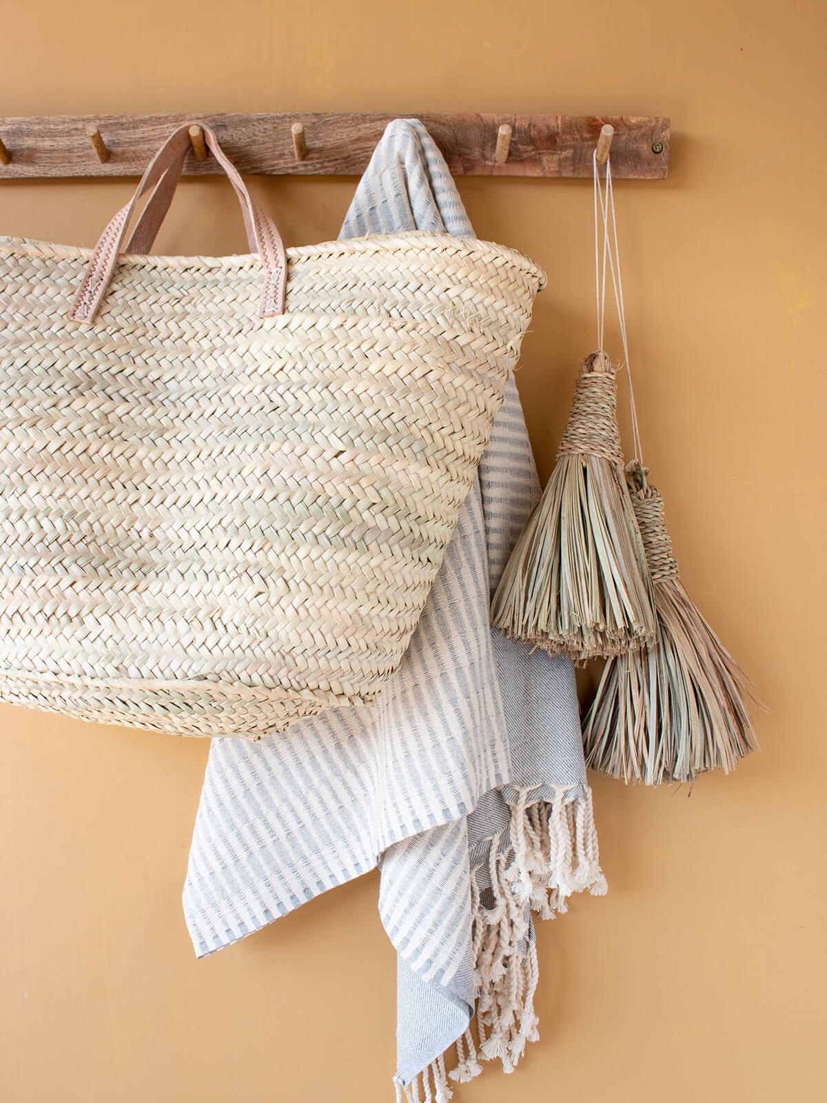 Parisienne market basket hanging on a wooden hook by Bohemia Design