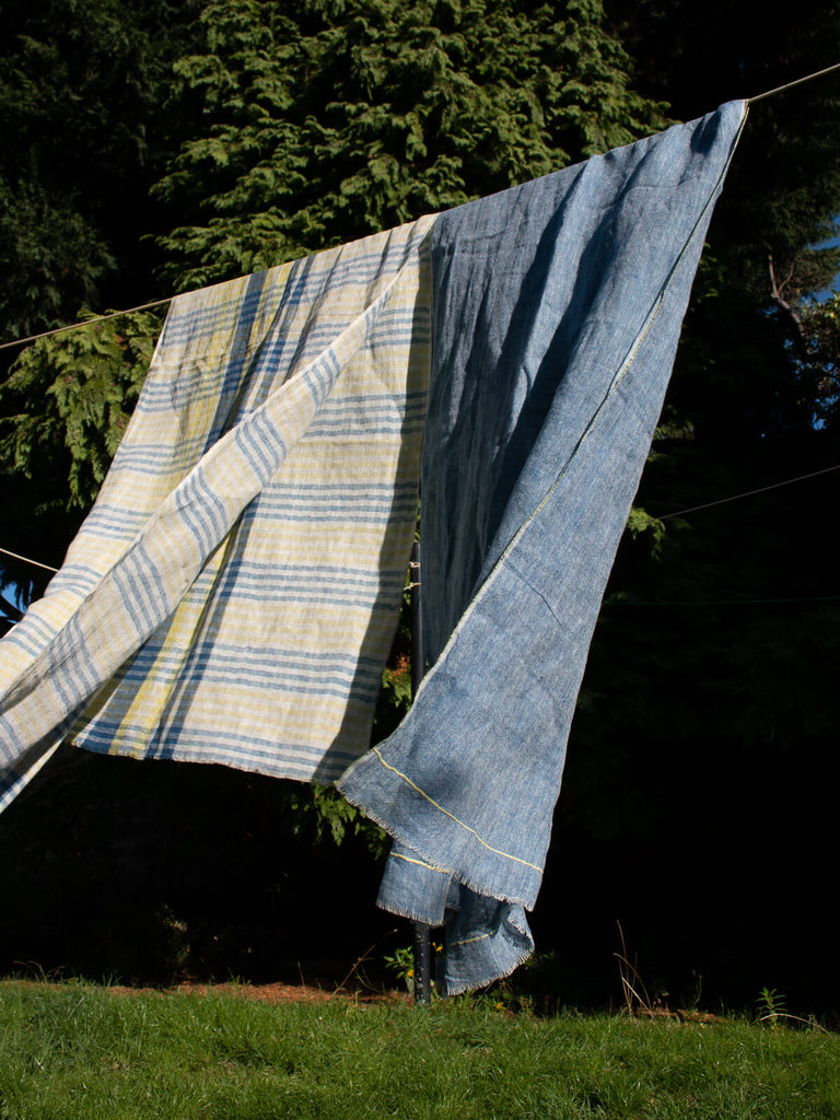 Linen Scarf in Indigo and Lemon hanging on a washing line