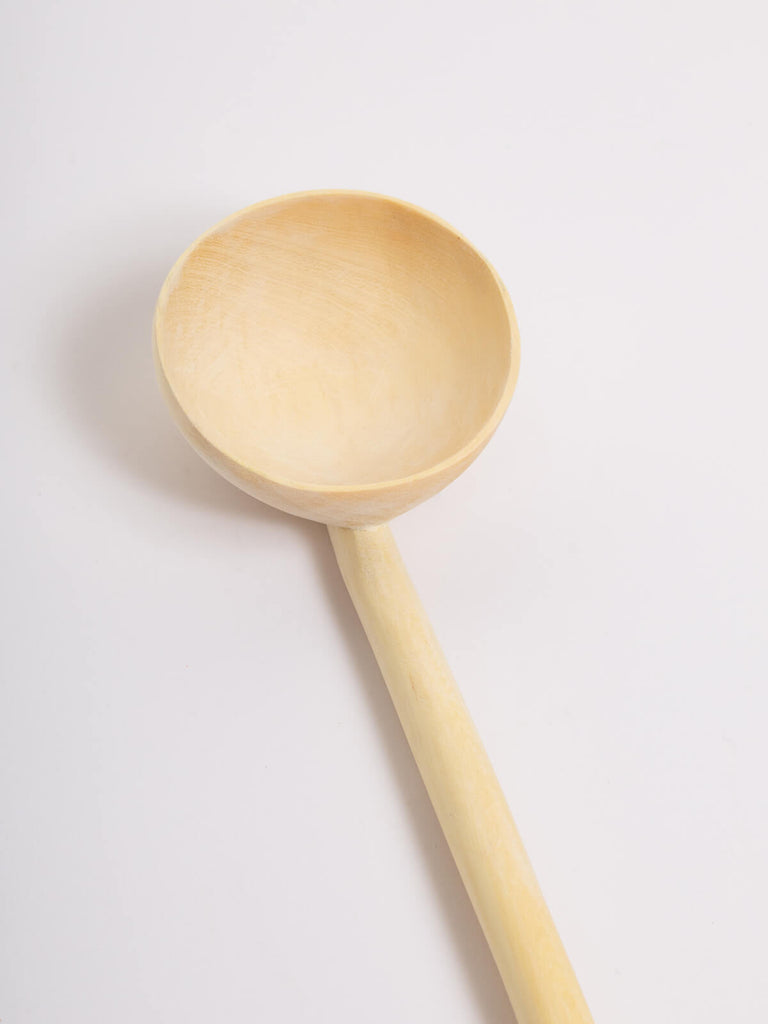Close up of a large lemon wood spoon.