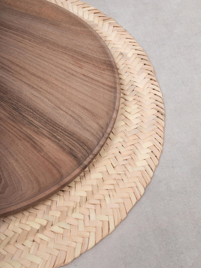 Large Walnut Wood Plate on a palm leaf placemat.