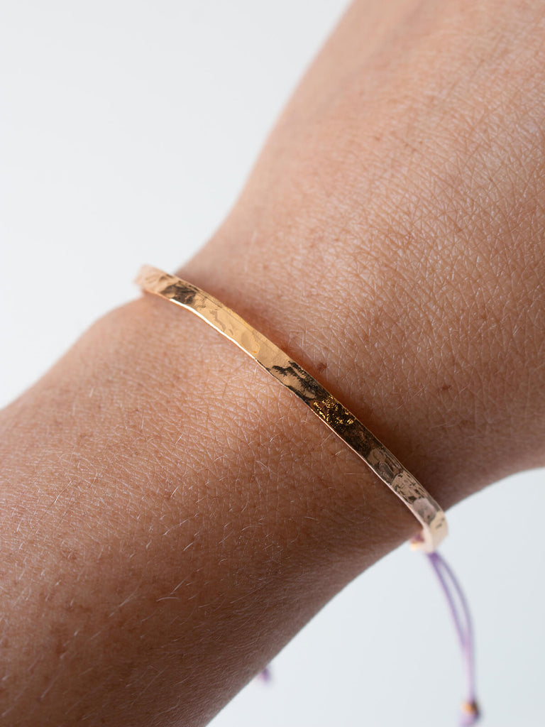 Woman wearing Gold celeste bracelet with lilac silk thread by Bohemia Design