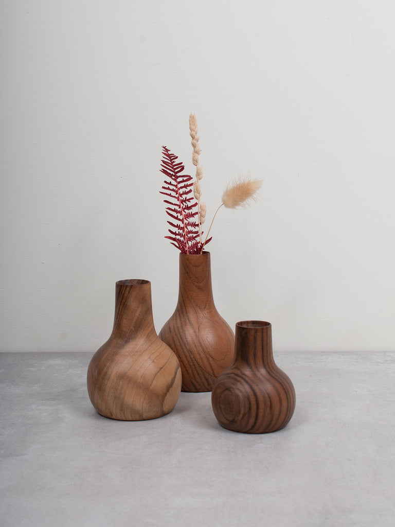 Group of three mini walnut wood vases with dried flowers