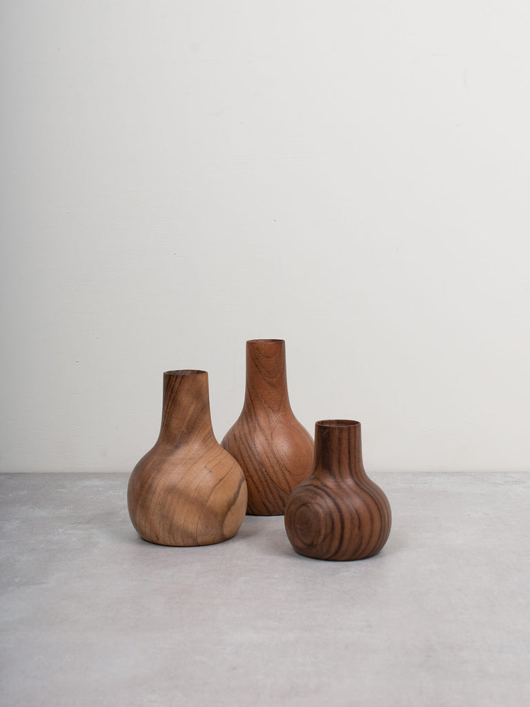 Three Walnut wood mini vases by Bohemia Design on grey tiles