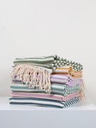 Pile of folded colourful Nordic Dot hammam towels by Bohemia Design